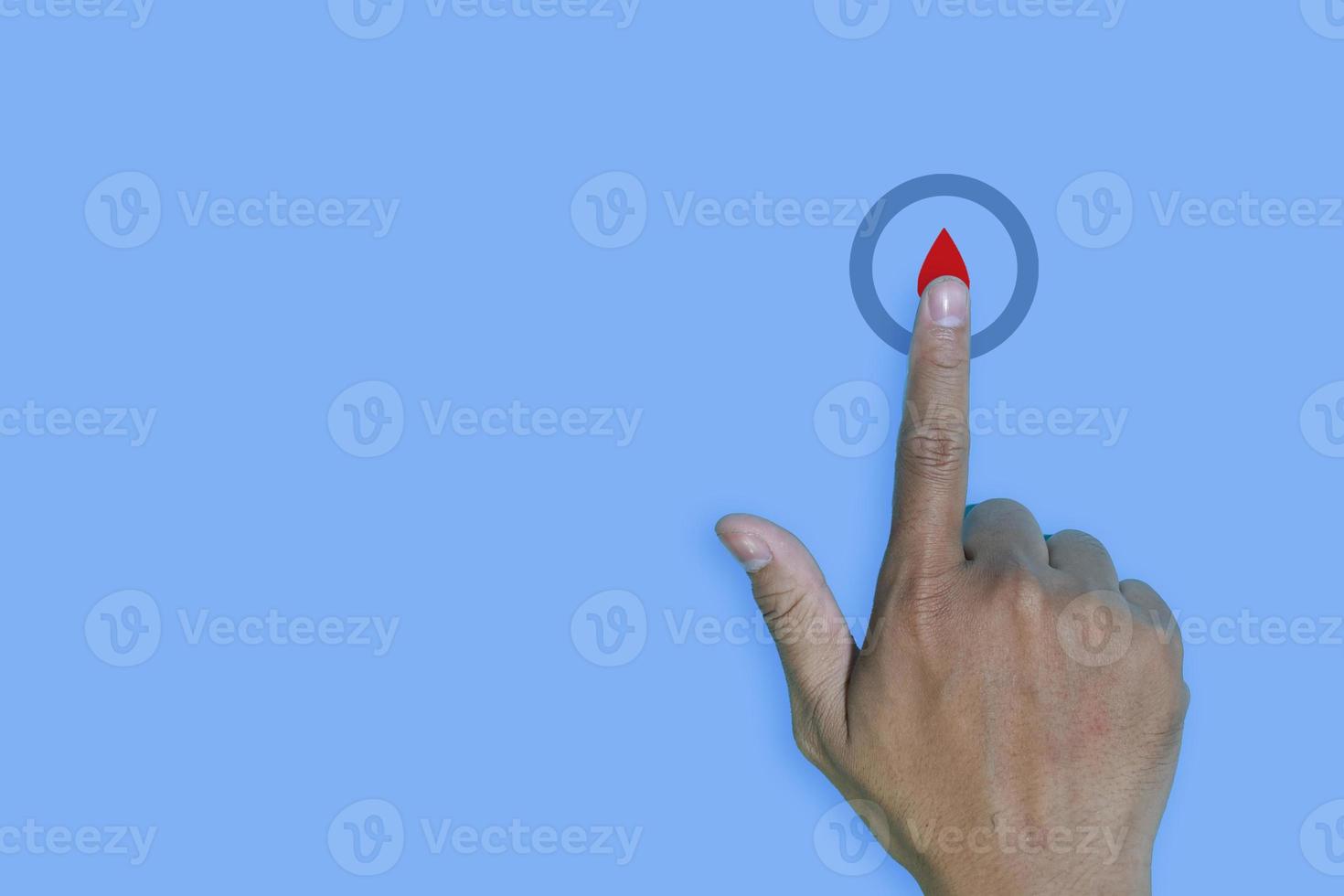 copyspace world diabetes day and hand gesture with red blood drop in man hands isolated on a blue background. 14 november photo