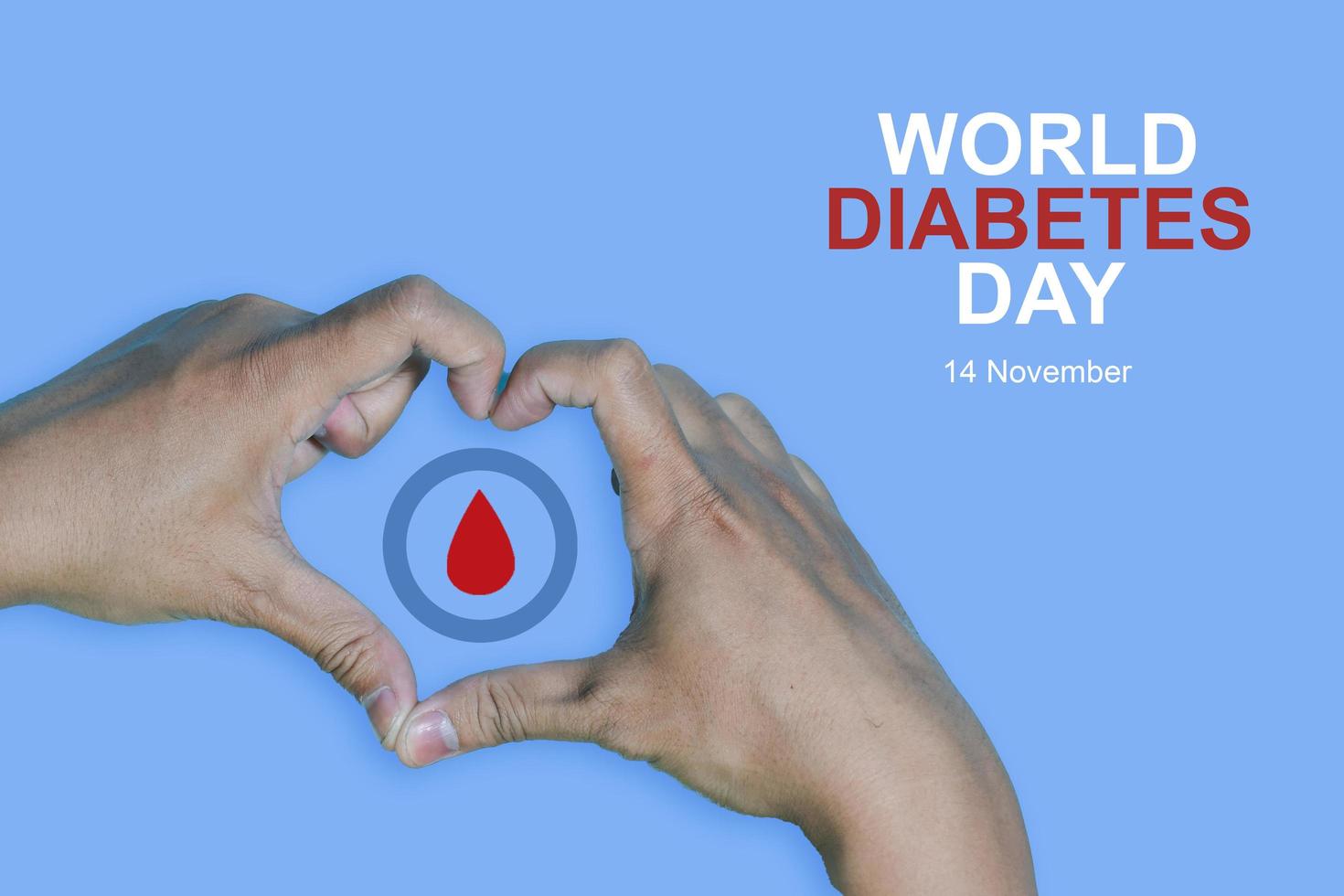 Top view inscription world diabetes day and hand gesture with red blood drop in man hands isolated on a blue background. World diabetes day, 14 november. Copy space, Health Awareness photo