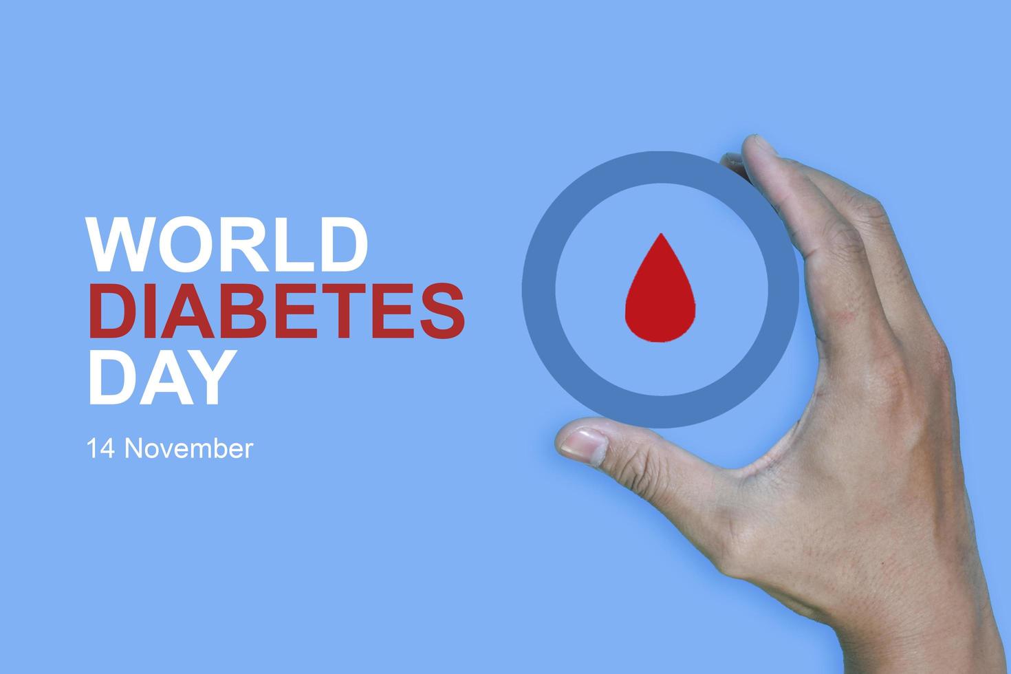 Top view inscription world diabetes day and hand gesture with red blood drop in man hands isolated on a blue background. World diabetes day, 14 november. Copy space, Health Awareness photo