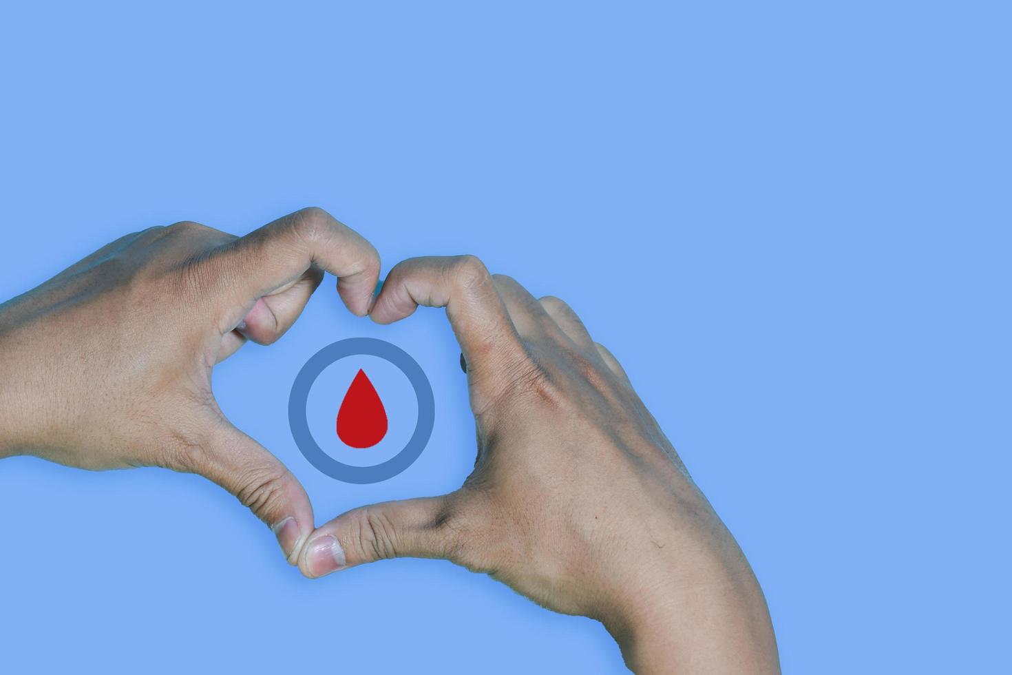 Top view inscription world diabetes day and hand gesture with red blood drop in man hands isolated on a blue background. World diabetes day, 14 november. Copy space, Health Awareness photo