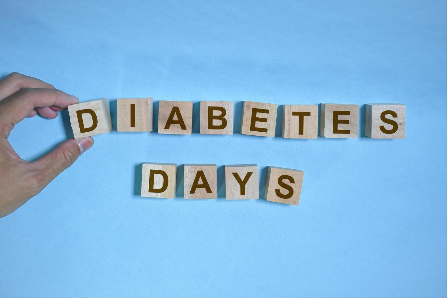 Word blocks with the words diabetes day on blue background, health awareness, world diabetes days, 14 november photo