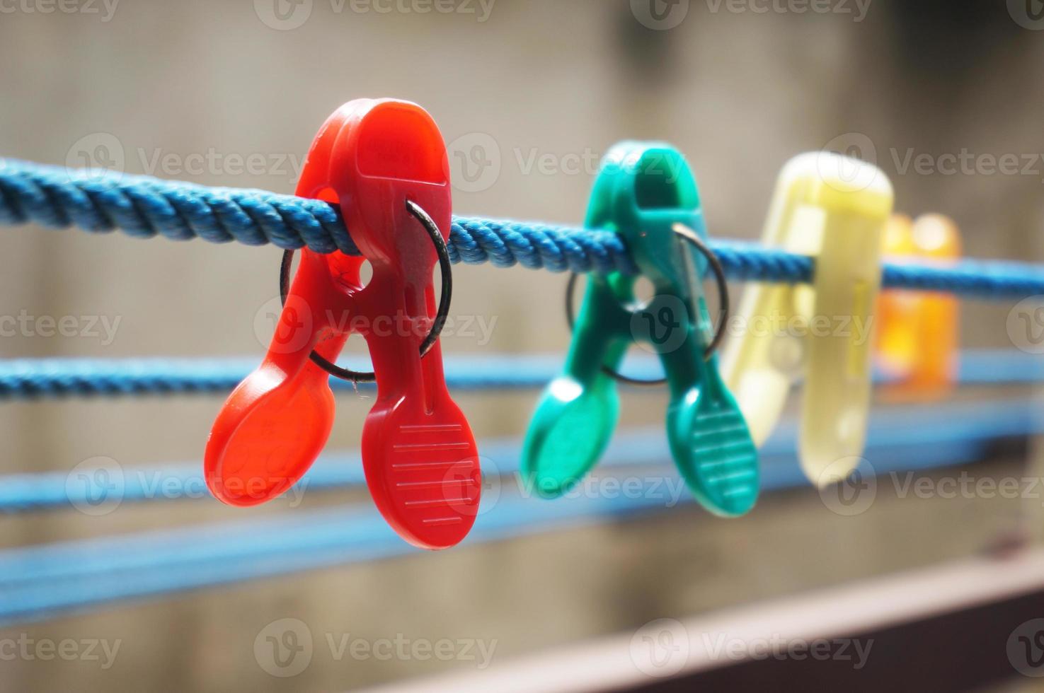 Colorful clothespin clothespins on the hangers. Plastic clothespins in different colors. photo