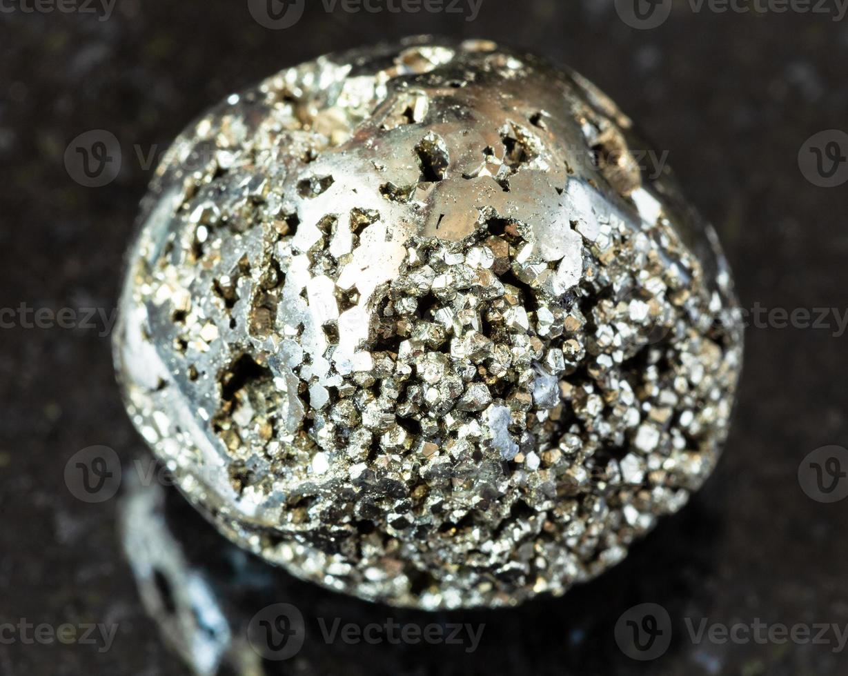 polished Pyrite fool's gold rock on black photo
