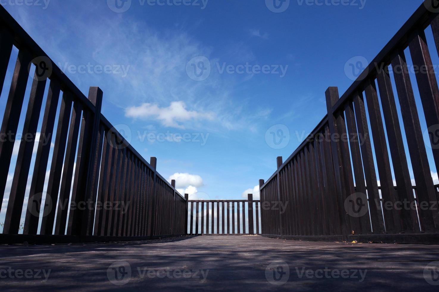 Wooden bridge on blue sky background. photo