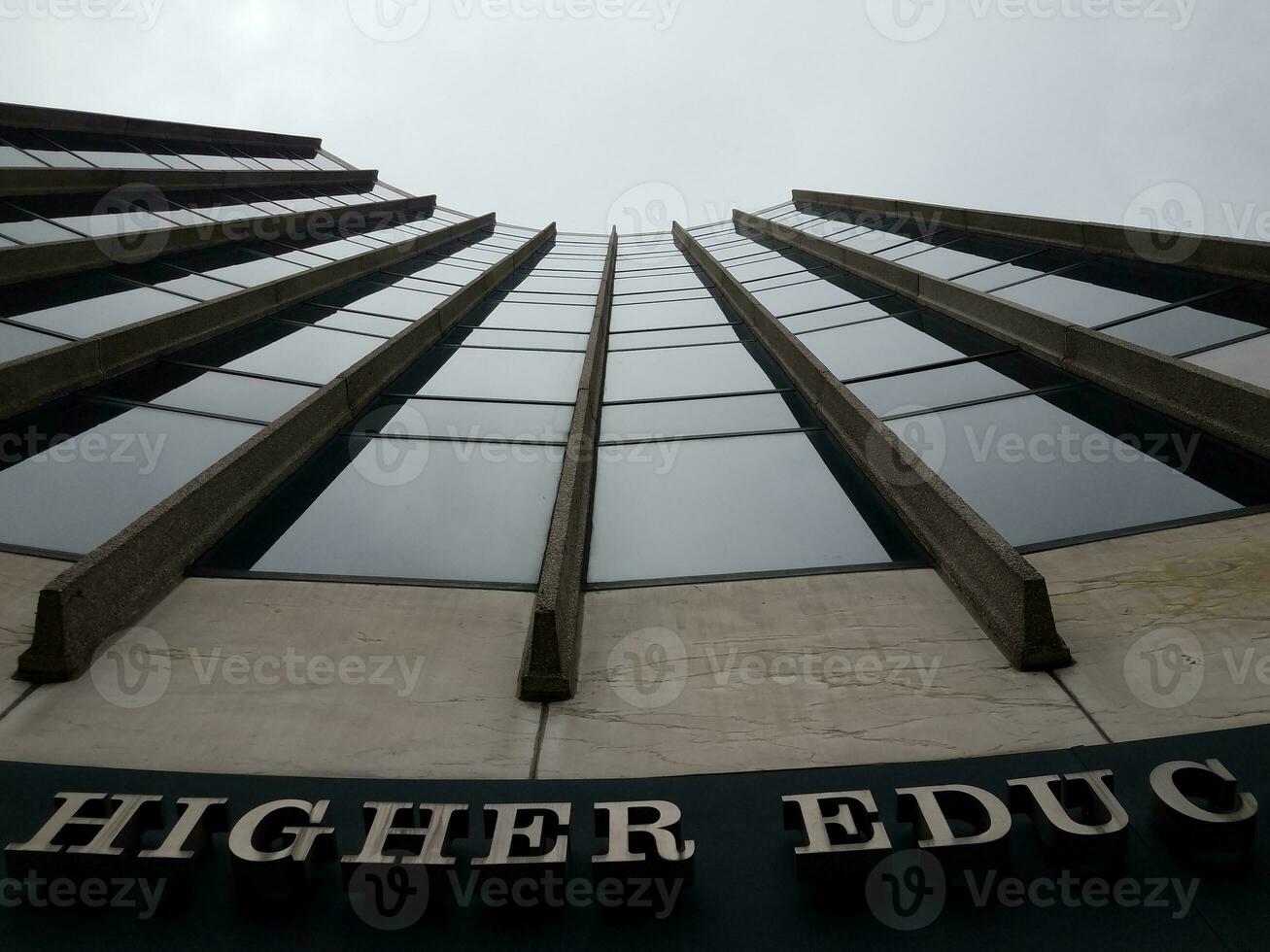 looking up at tall higher education building skyscraper photo