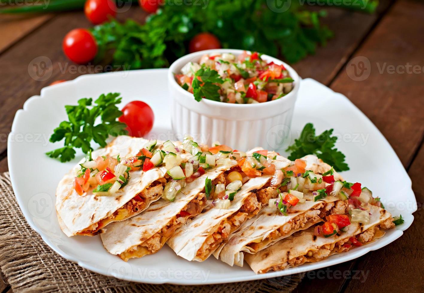 Mexican Quesadilla wrap with chicken, corn and sweet pepper and salsa photo