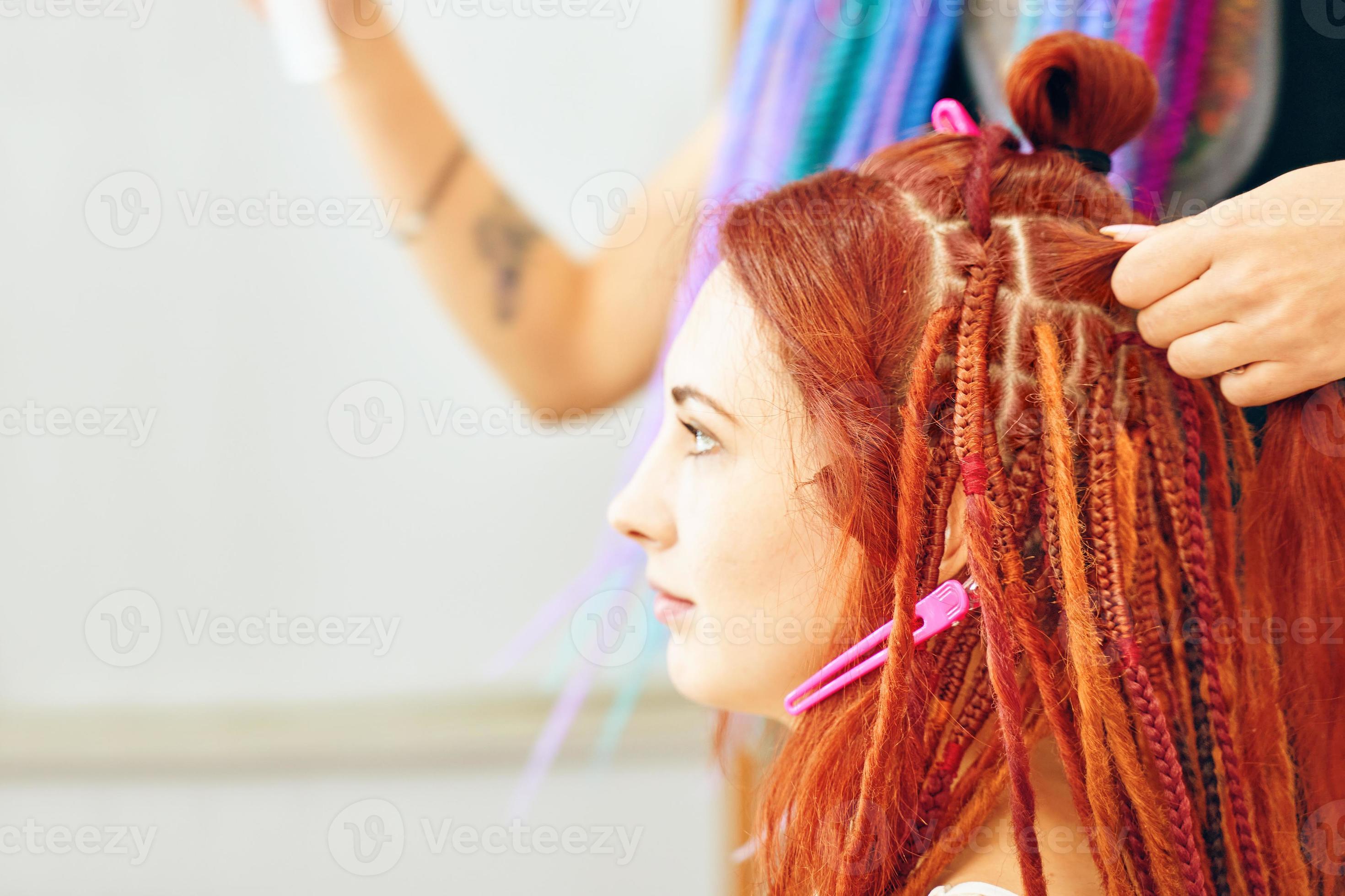 Hairdresser weaves braids with kanekalon to young girl head. 14260493 Stock  Photo at Vecteezy