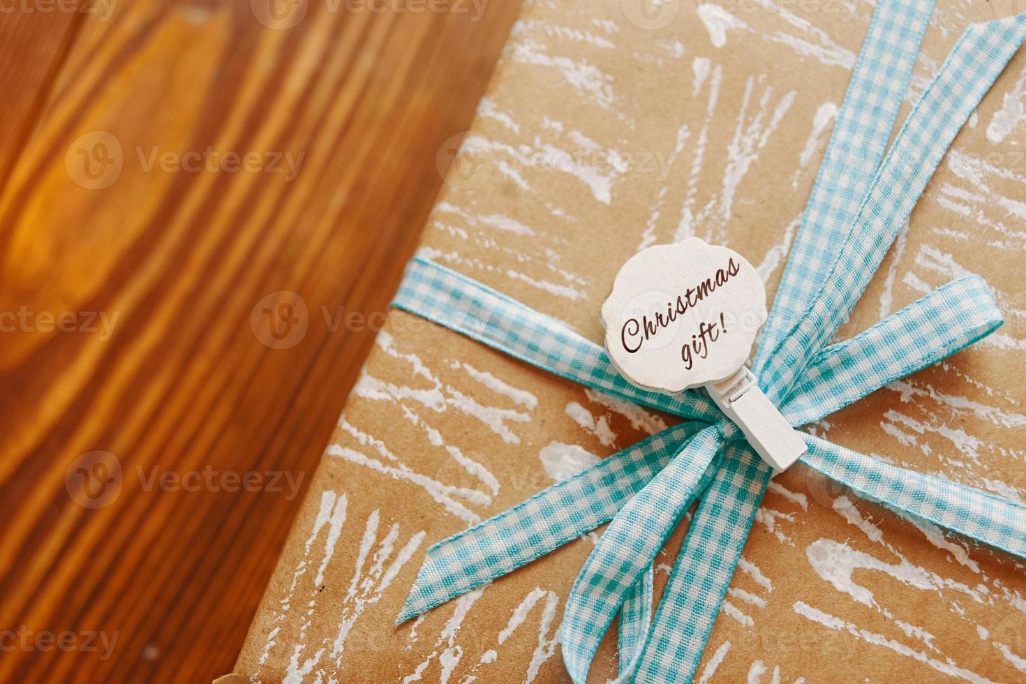 Christmas gift box on wooden table. photo