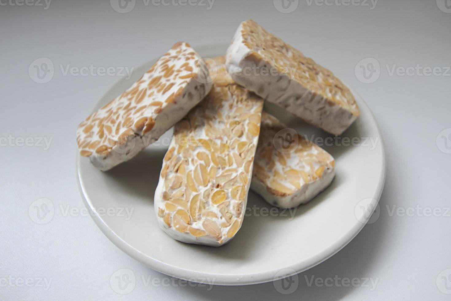 Tempeh Or Tempe is Indonesian traditional food made from fermented soybeans. They are usually wrapped in banana leaves photo