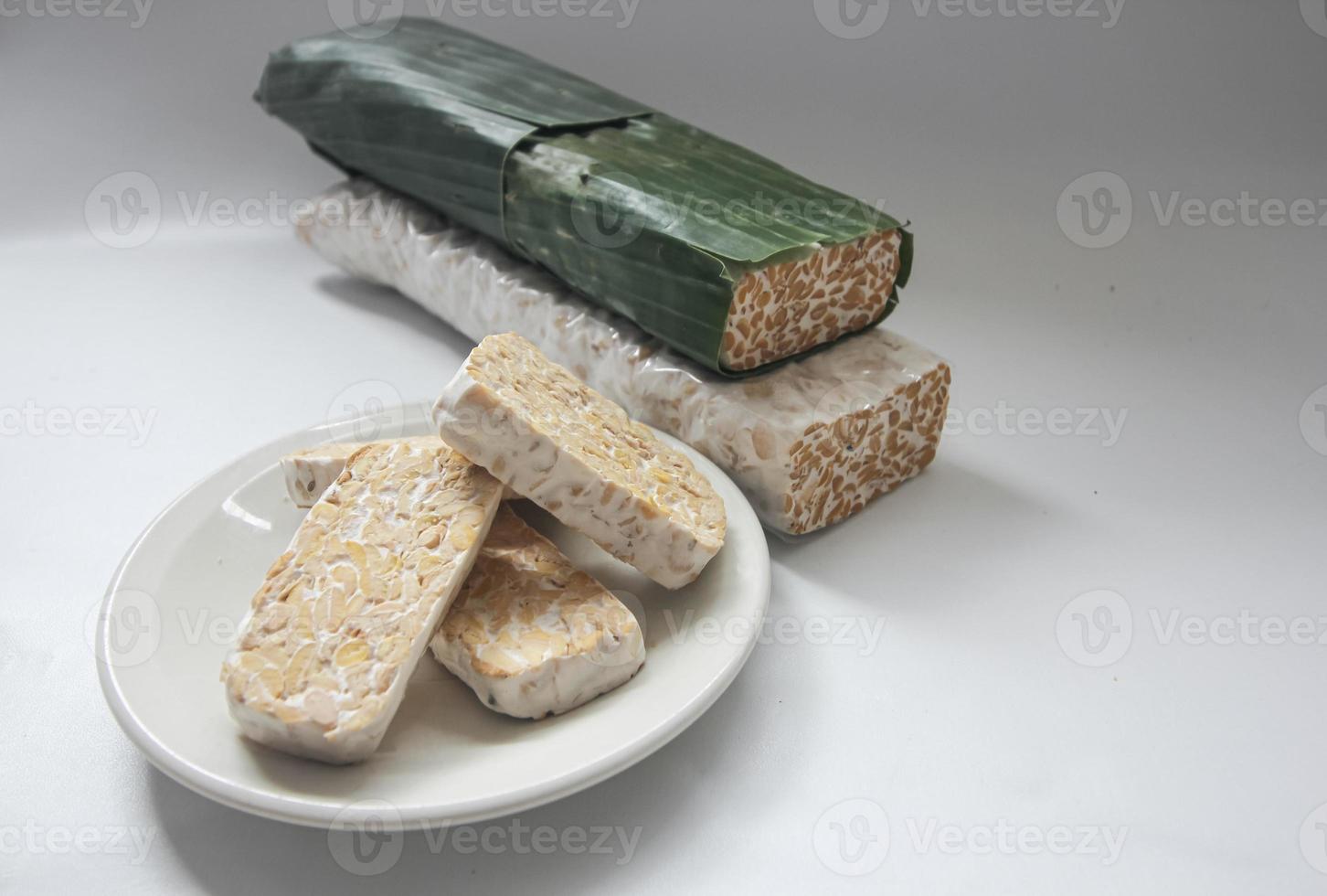 Tempeh Or Tempe is Indonesian traditional food made from fermented soybeans. They are usually wrapped in banana leaves photo