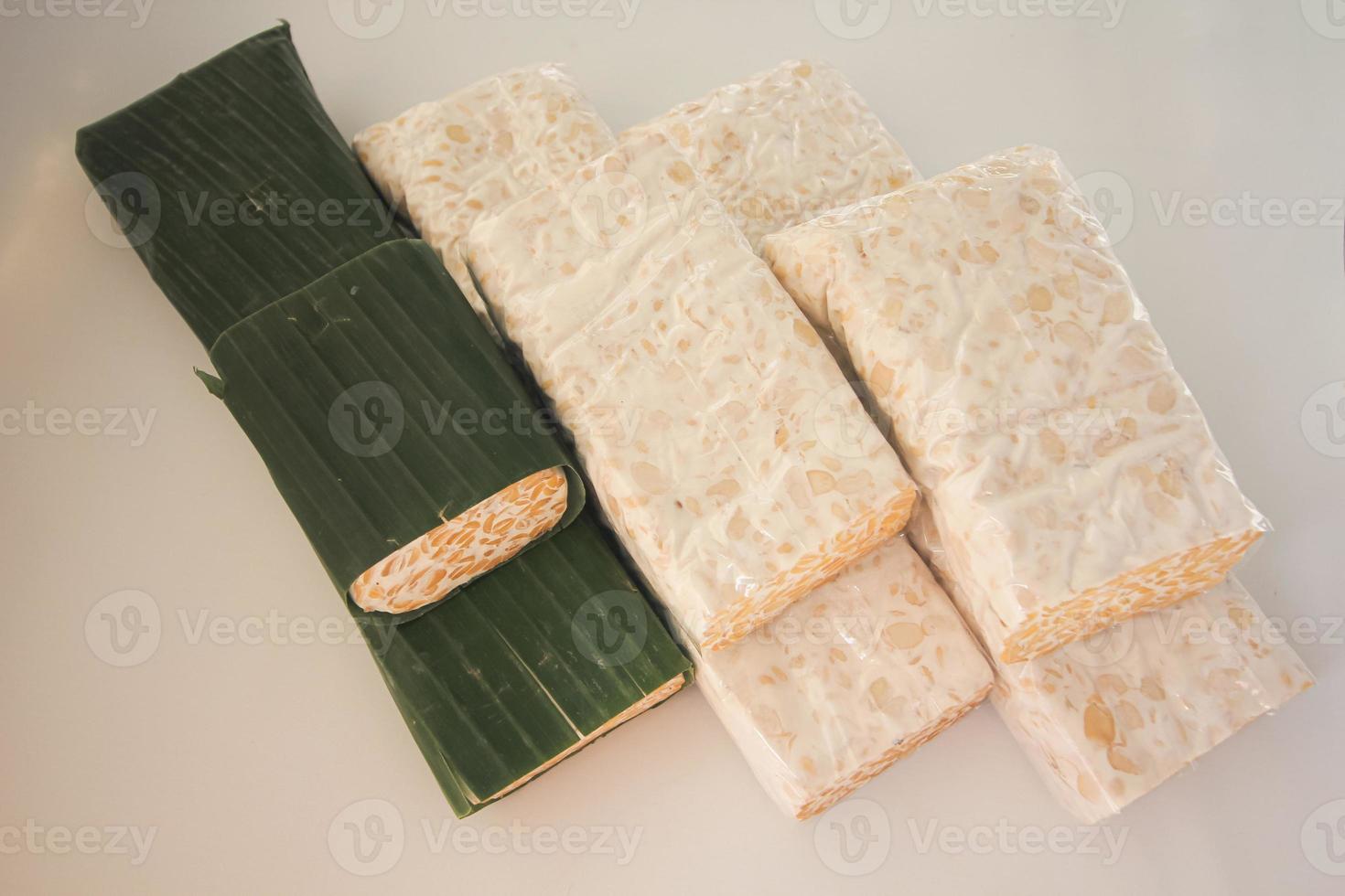 Tempeh Or Tempe is Indonesian traditional food made from fermented soybeans. They are usually wrapped in banana leaves photo