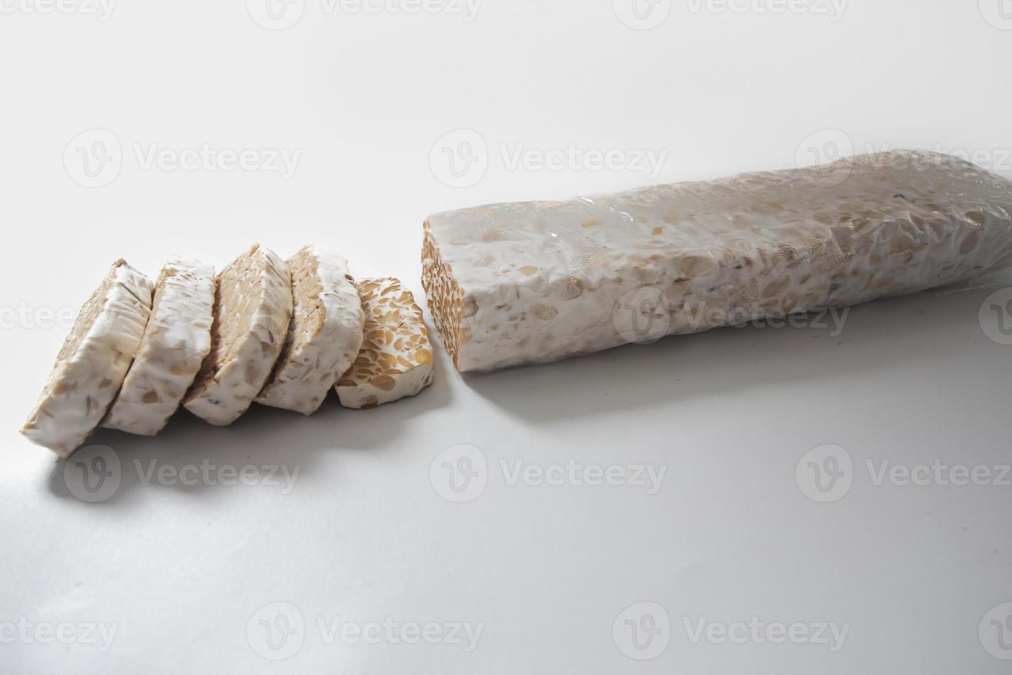 Tempeh Or Tempe is Indonesian traditional food made from fermented soybeans. They are usually wrapped in banana leaves photo