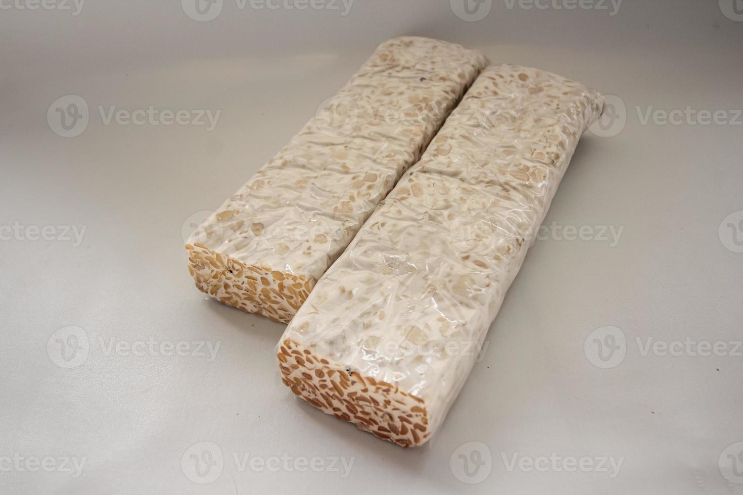 Tempeh Or Tempe is Indonesian traditional food made from fermented soybeans. They are usually wrapped in banana leaves photo