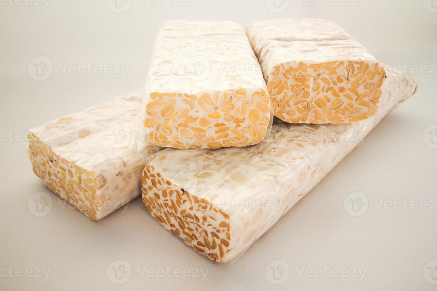 Tempeh Or Tempe is Indonesian traditional food made from fermented soybeans. They are usually wrapped in banana leaves photo