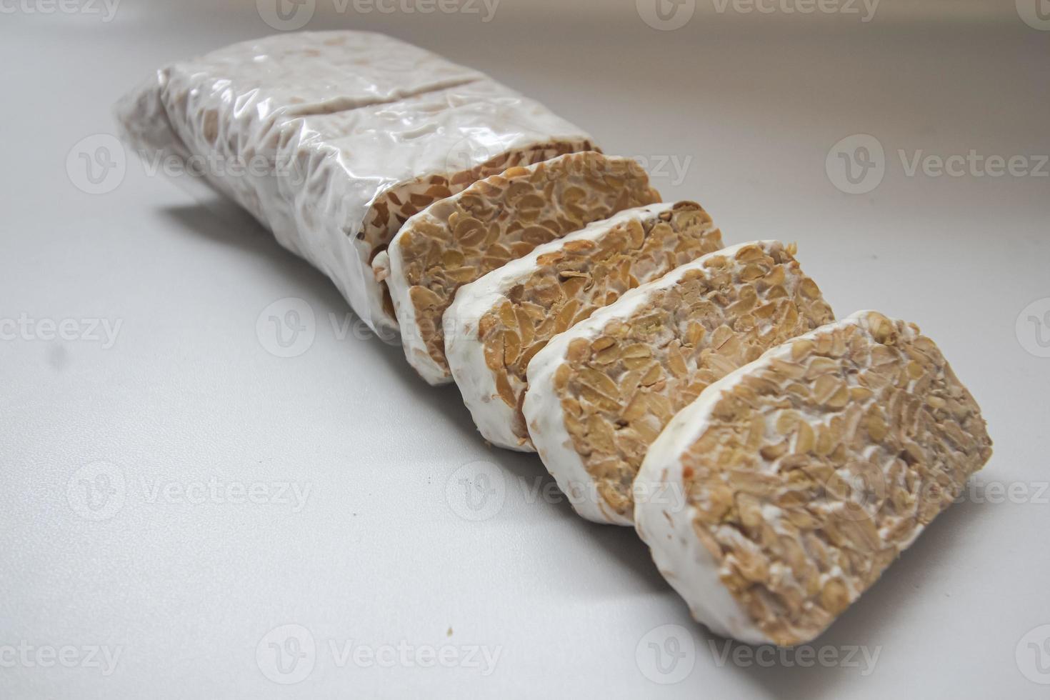 Tempeh Or Tempe is Indonesian traditional food made from fermented soybeans. They are usually wrapped in banana leaves photo