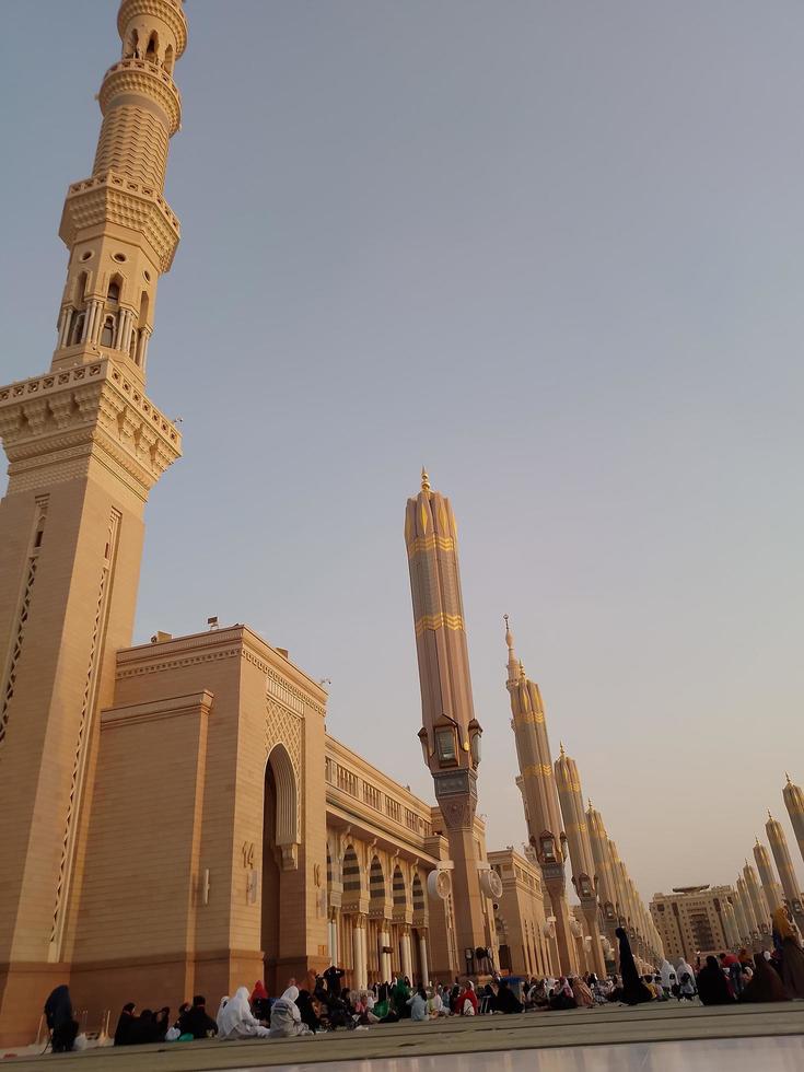 Medina, Saudi Arabia, 2022 - Umbrella construction on the square of Al-Masjid An-Nabawi or Prophet Muhammed Mosque are protecting people from sun at daytime and work as lights at night photo