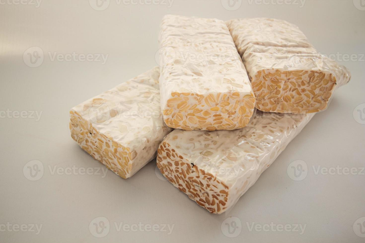 Tempeh Or Tempe is Indonesian traditional food made from fermented soybeans. They are usually wrapped in banana leaves photo