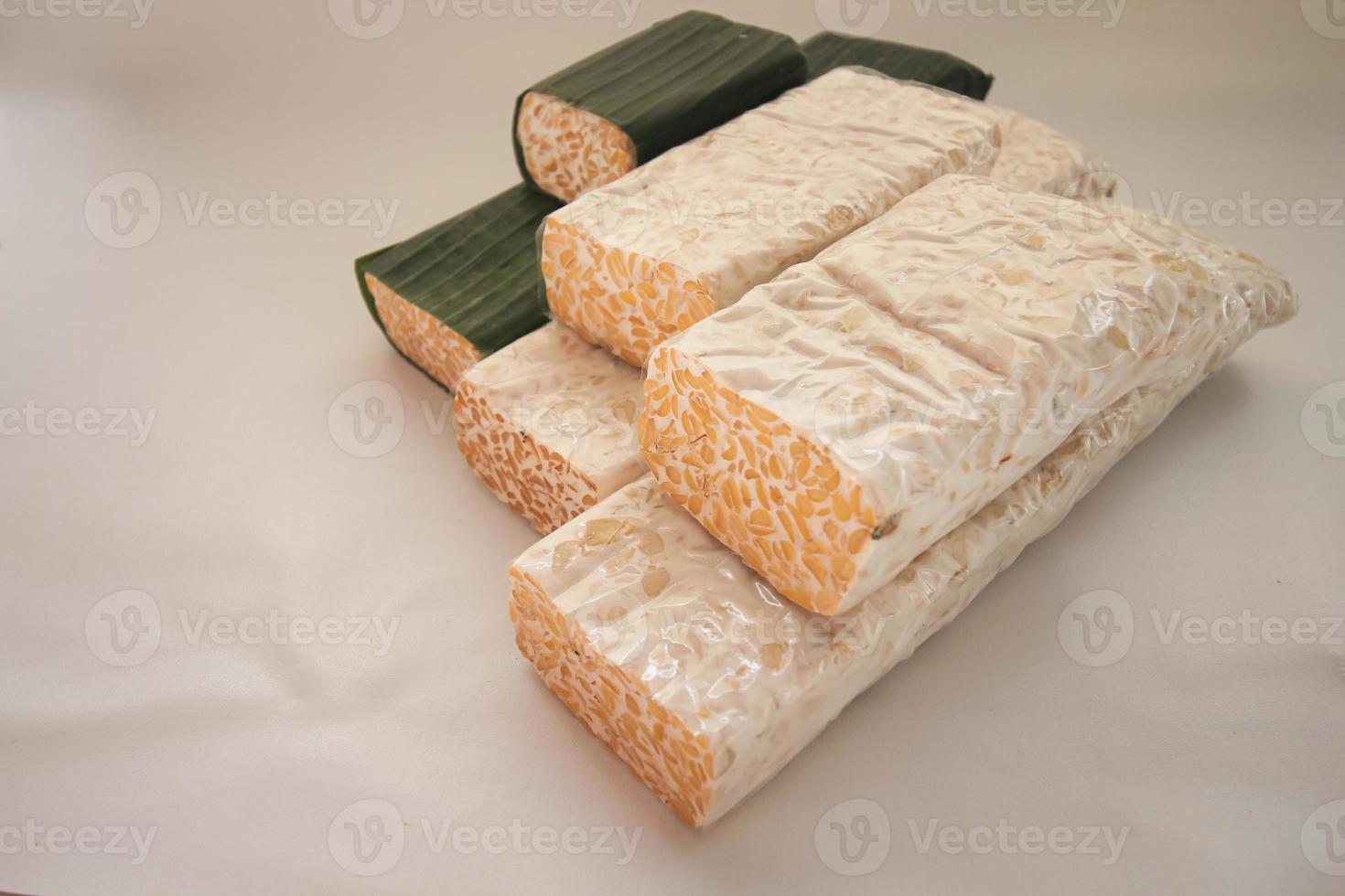 Tempeh Or Tempe is Indonesian traditional food made from fermented soybeans. They are usually wrapped in banana leaves photo