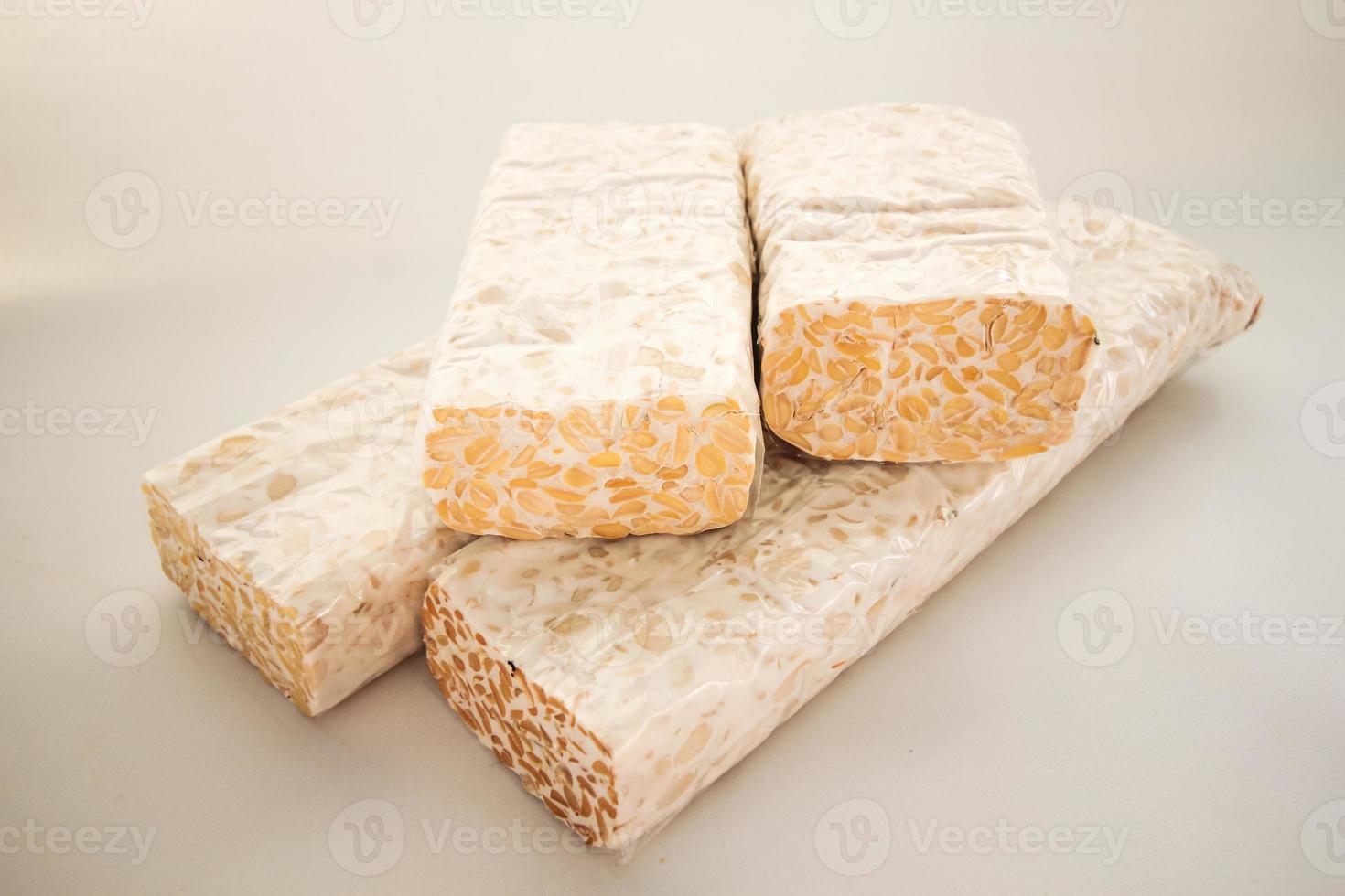 Tempeh or Tempe is Indonesian traditional food made from fermented soybeans. They are usually wrapped in banana leaves photo