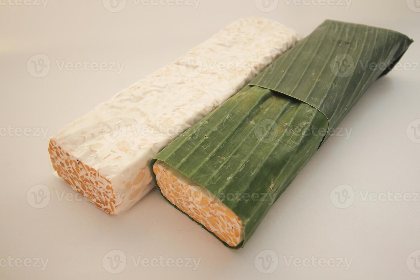 Tempeh or Tempe is Indonesian traditional food made from fermented soybeans. They are usually wrapped in banana leaves photo