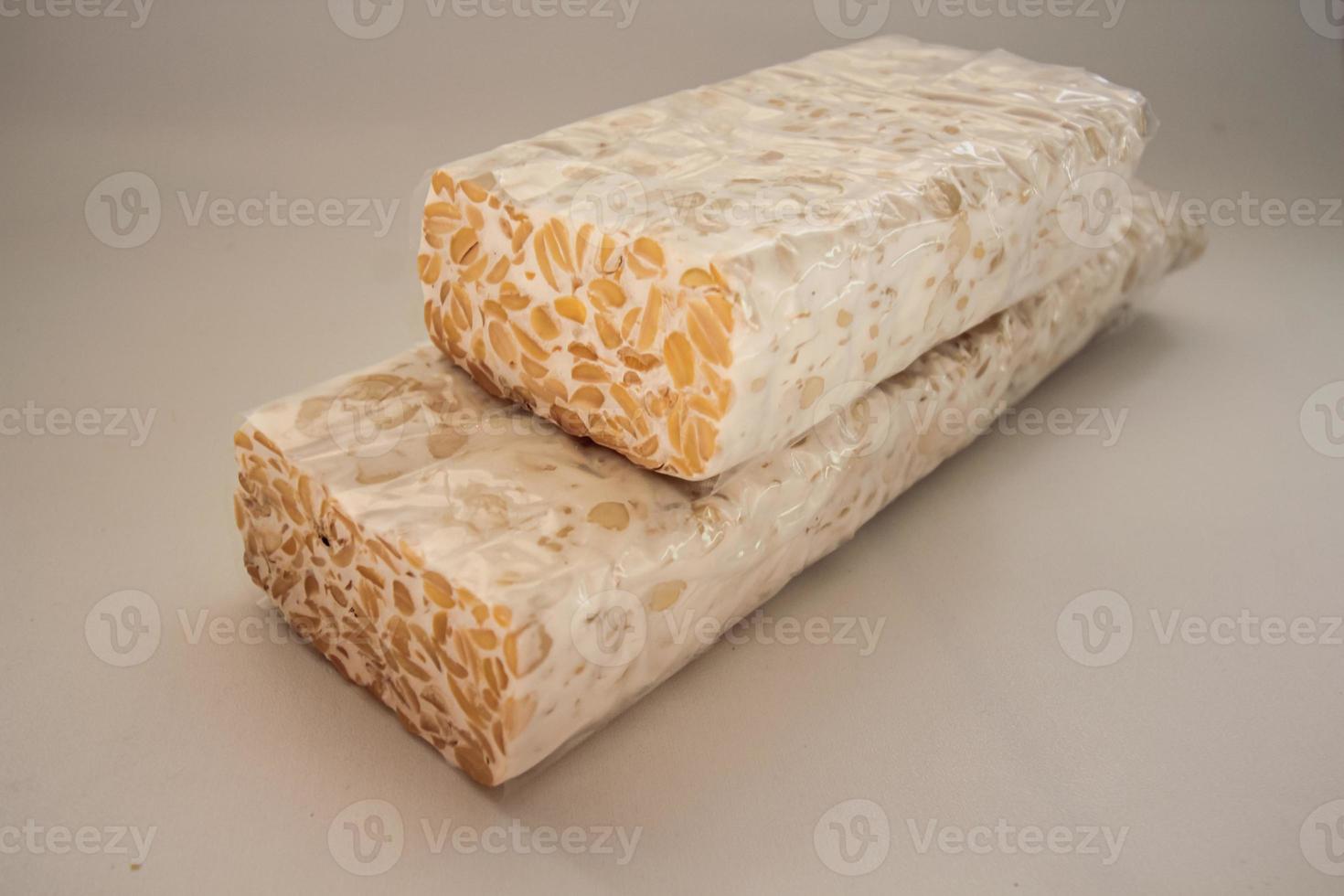 Tempeh Or Tempe is Indonesian traditional food made from fermented soybeans. They are usually wrapped in banana leaves photo