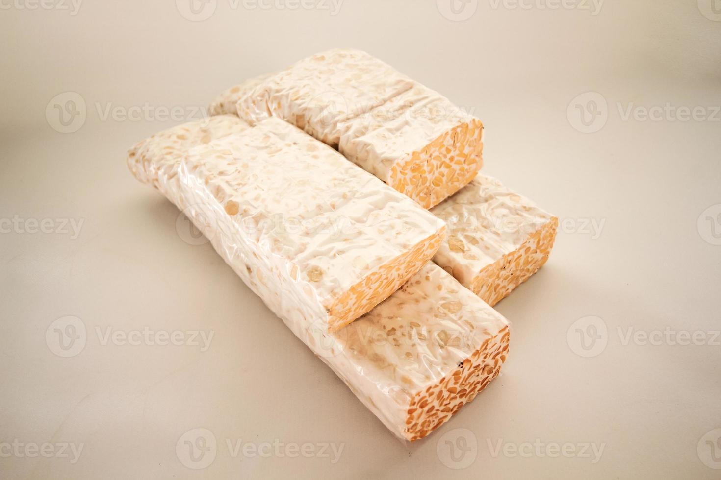 Tempeh Or Tempe is Indonesian traditional food made from fermented soybeans. They are usually wrapped in banana leaves photo