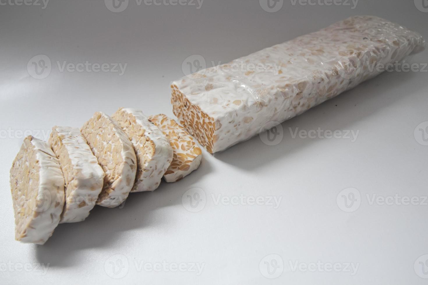 Tempeh Or Tempe is Indonesian traditional food made from fermented soybeans. They are usually wrapped in banana leaves photo