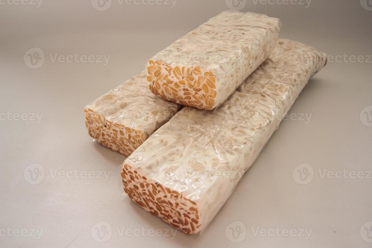 Tempeh Or Tempe is Indonesian traditional food made from fermented soybeans. They are usually wrapped in banana leaves photo