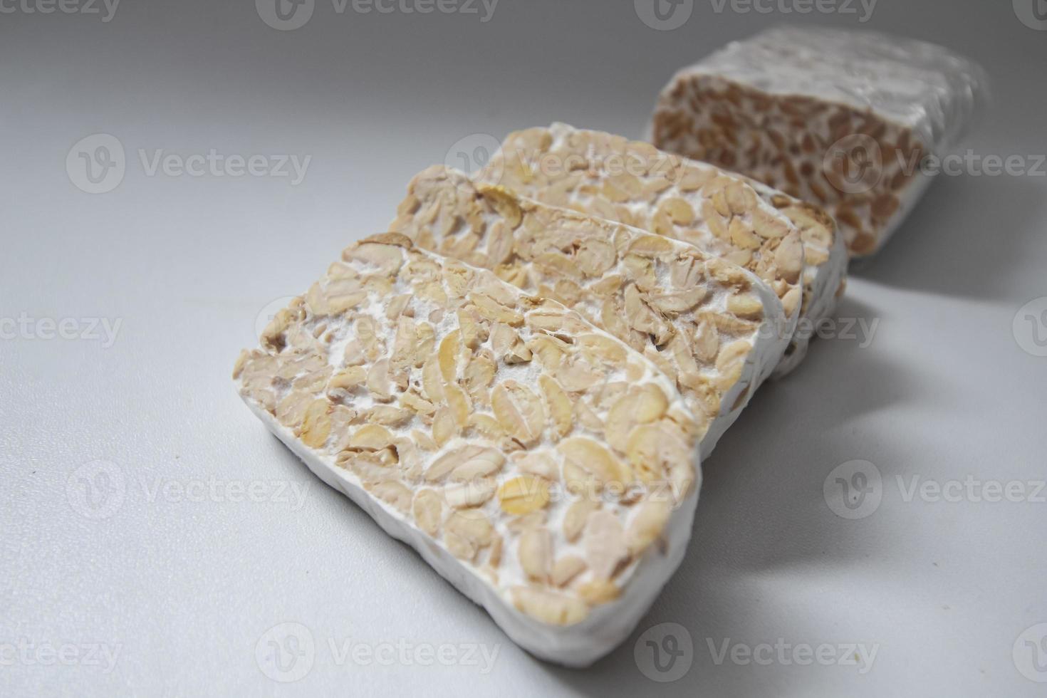 Tempeh Or Tempe is Indonesian traditional food made from fermented soybeans. They are usually wrapped in banana leaves photo