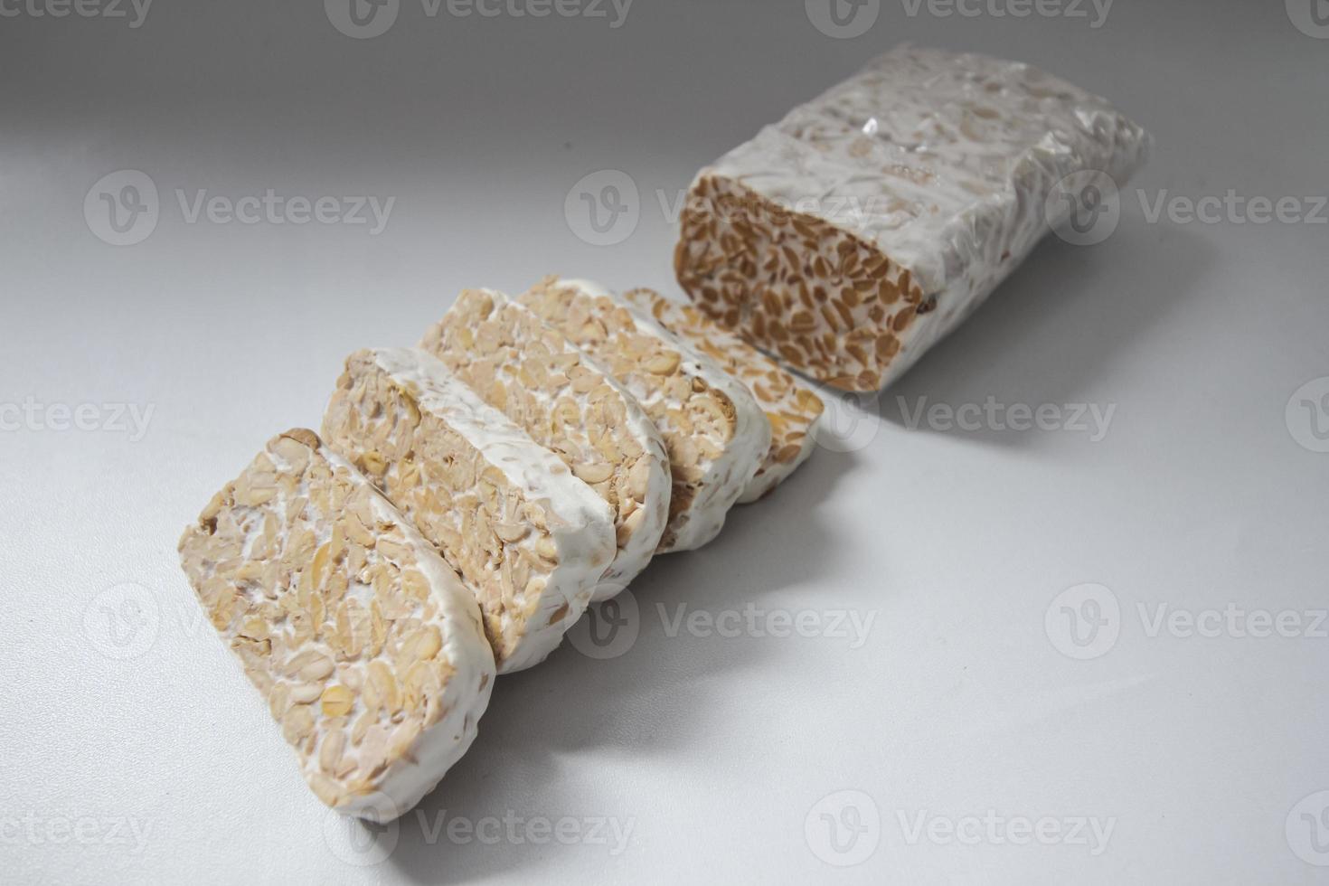Tempeh Or Tempe is Indonesian traditional food made from fermented soybeans. They are usually wrapped in banana leaves photo