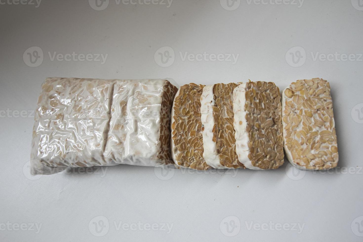 Tempeh Or Tempe is Indonesian traditional food made from fermented soybeans. They are usually wrapped in banana leaves photo