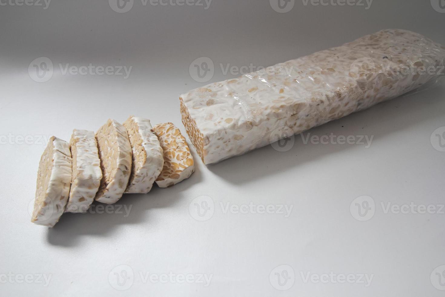 Tempeh Or Tempe is Indonesian traditional food made from fermented soybeans. They are usually wrapped in banana leaves photo