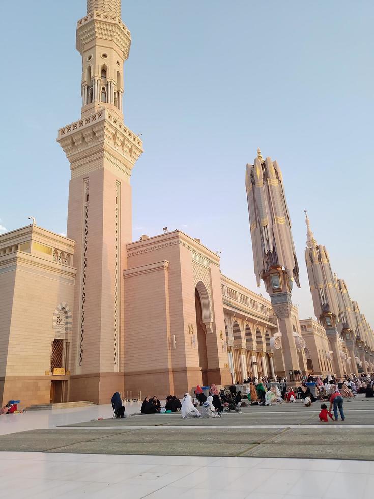 Medina, Saudi Arabia, 2022 - Umbrella construction on the square of Al-Masjid An-Nabawi or Prophet Muhammed Mosque are protecting people from sun at daytime and work as lights at night photo