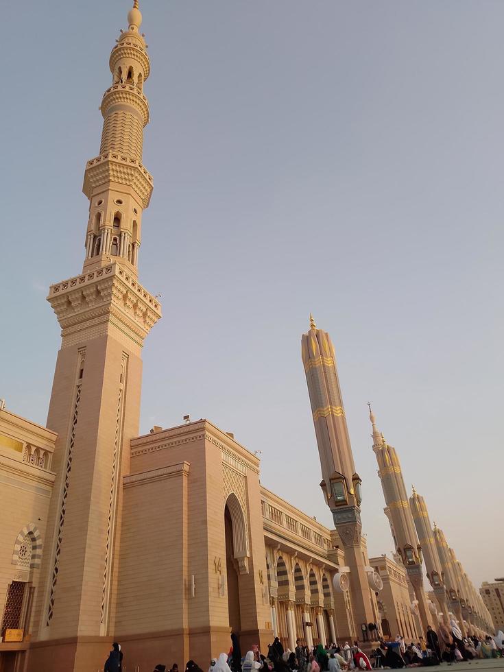 Medina, Saudi Arabia, 2022 - Umbrella construction on the square of Al-Masjid An-Nabawi or Prophet Muhammed Mosque are protecting people from sun at daytime and work as lights at night photo