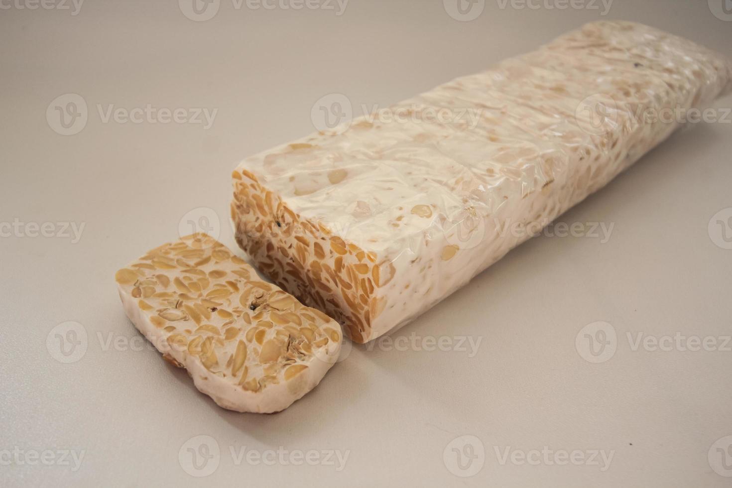 Tempeh Or Tempe is Indonesian traditional food made from fermented soybeans. They are usually wrapped in banana leaves photo