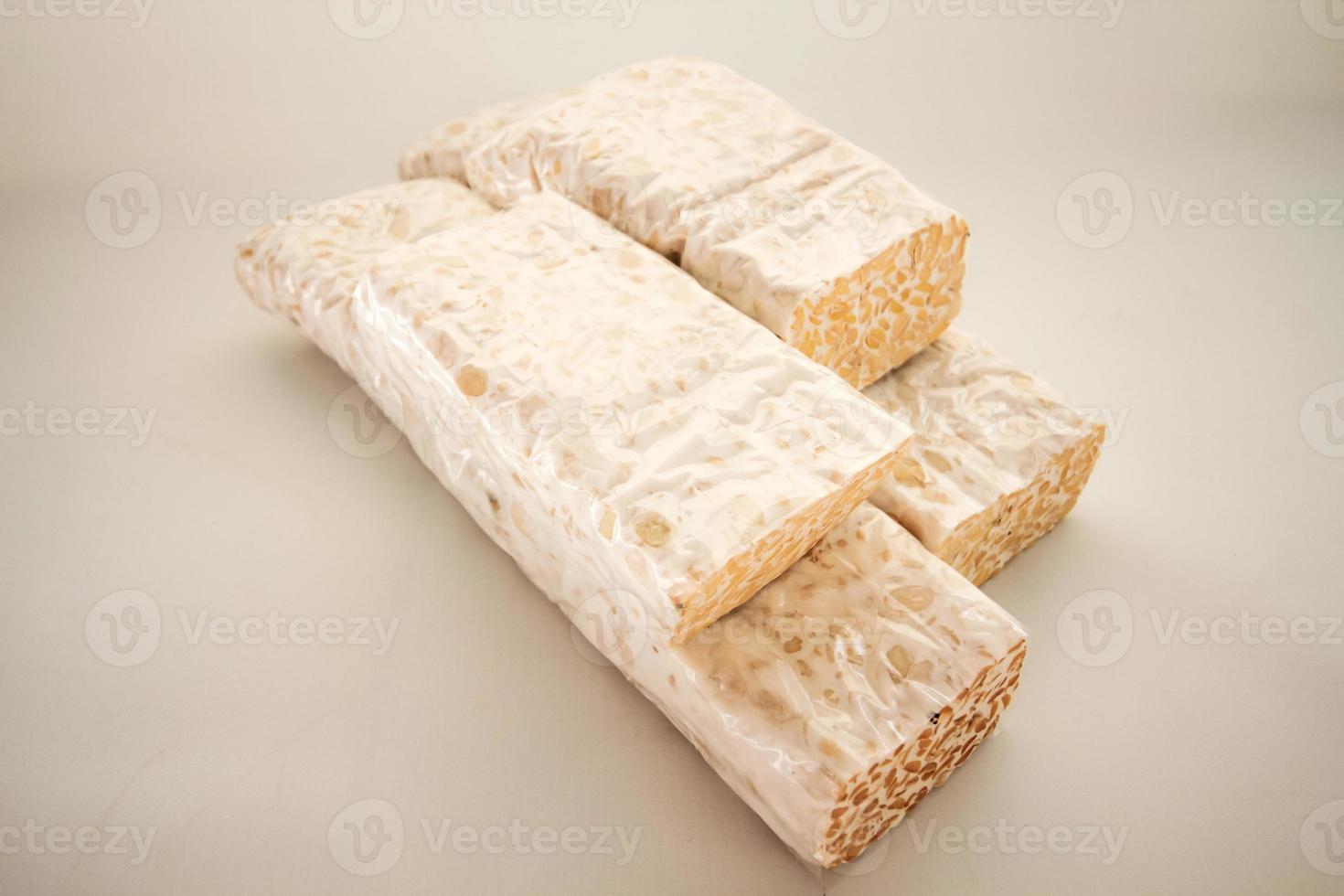 Tempeh or Tempe is Indonesian traditional food made from fermented soybeans. They are usually wrapped in banana leaves photo