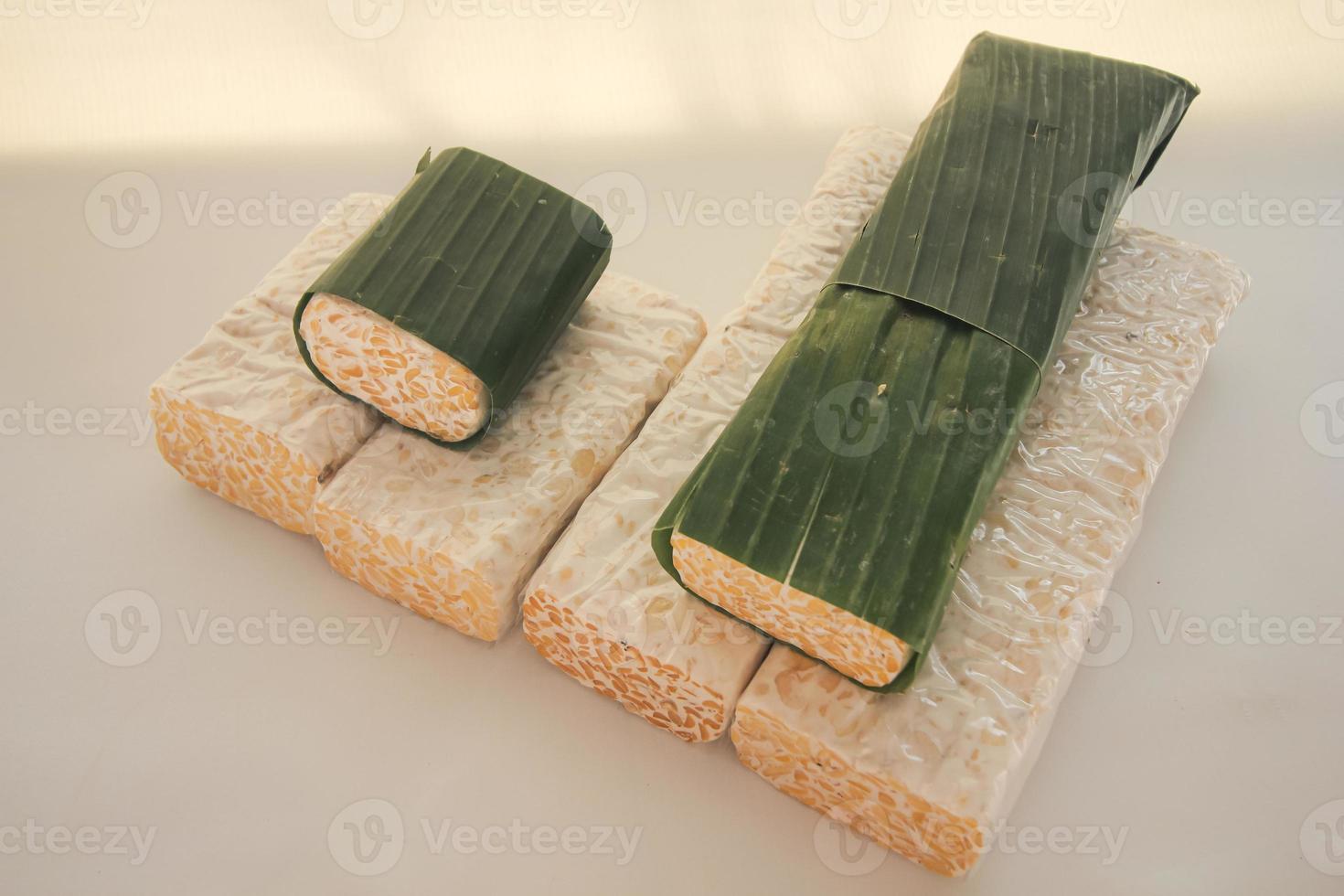 Tempeh Or Tempe is Indonesian traditional food made from fermented soybeans. They are usually wrapped in banana leaves photo