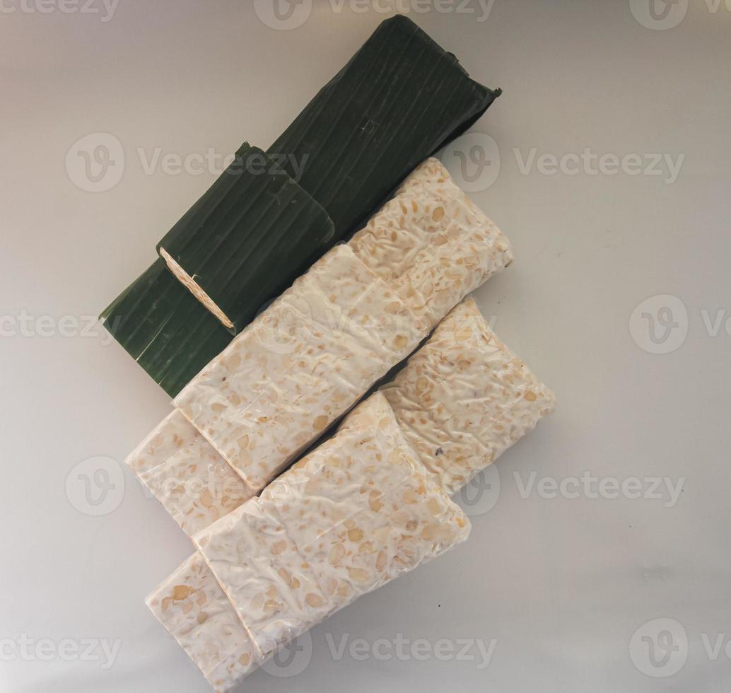 Tempeh Or Tempe is Indonesian traditional food made from fermented soybeans. They are usually wrapped in banana leaves photo