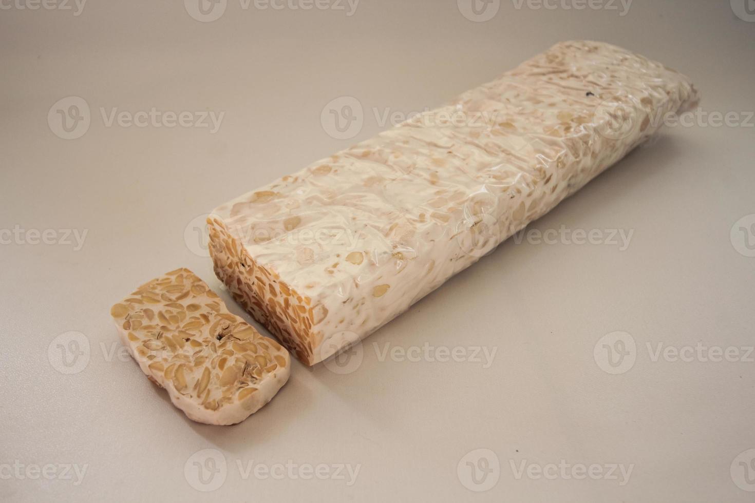 Tempeh Or Tempe is Indonesian traditional food made from fermented soybeans. They are usually wrapped in banana leaves photo