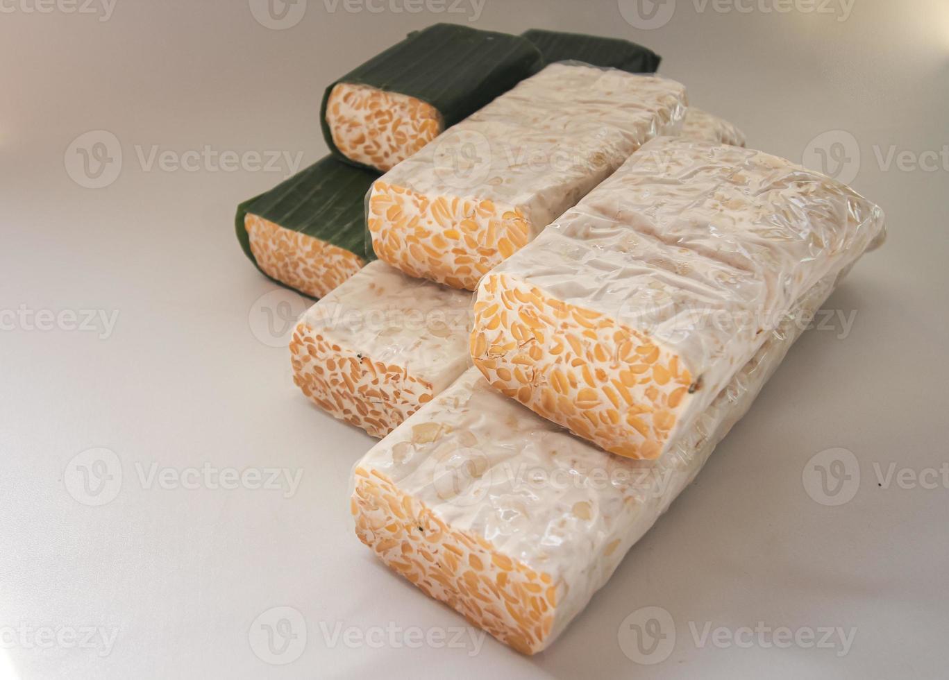 Tempeh Or Tempe is Indonesian traditional food made from fermented soybeans. They are usually wrapped in banana leaves photo