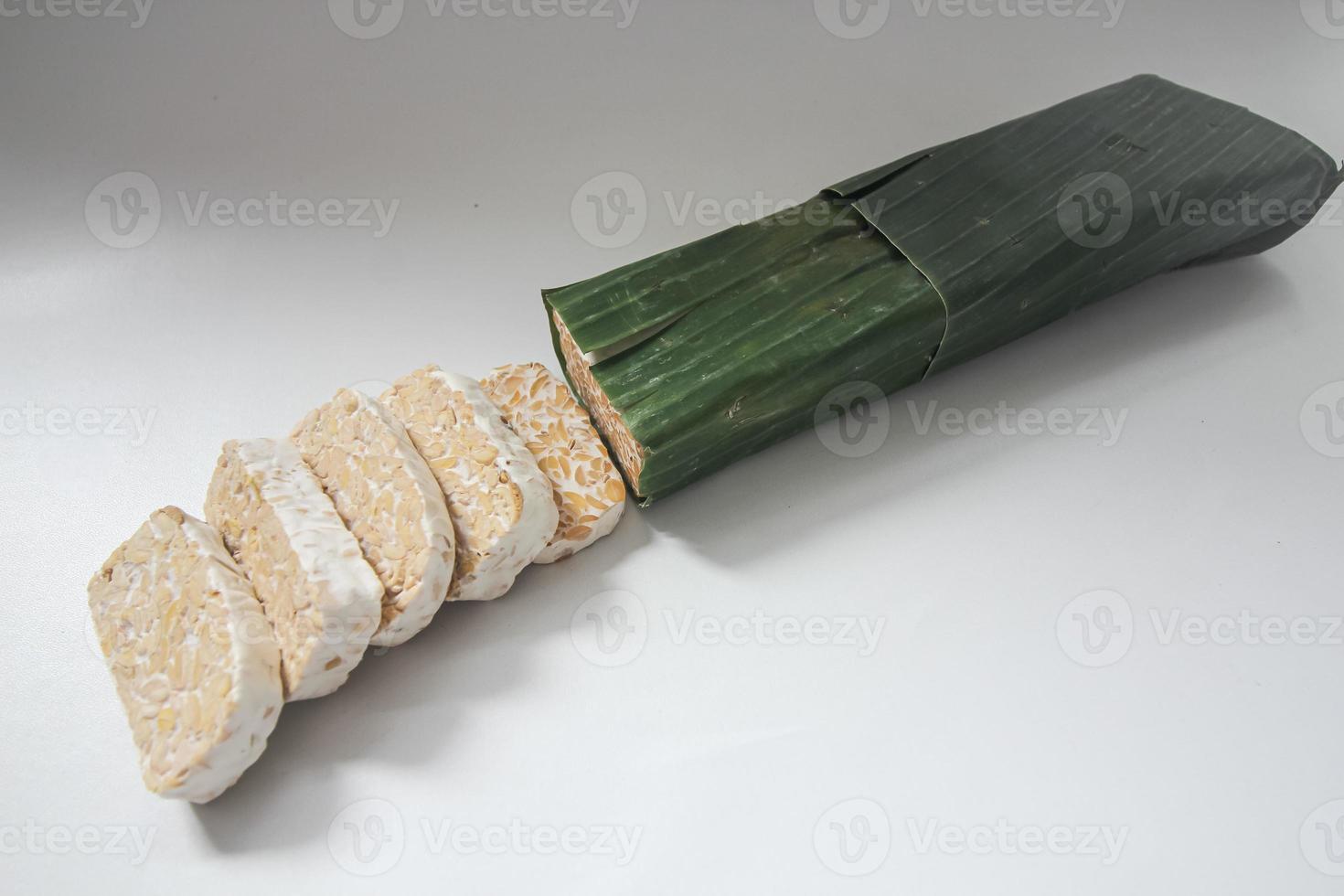 Tempeh Or Tempe is Indonesian traditional food made from fermented soybeans. They are usually wrapped in banana leaves photo