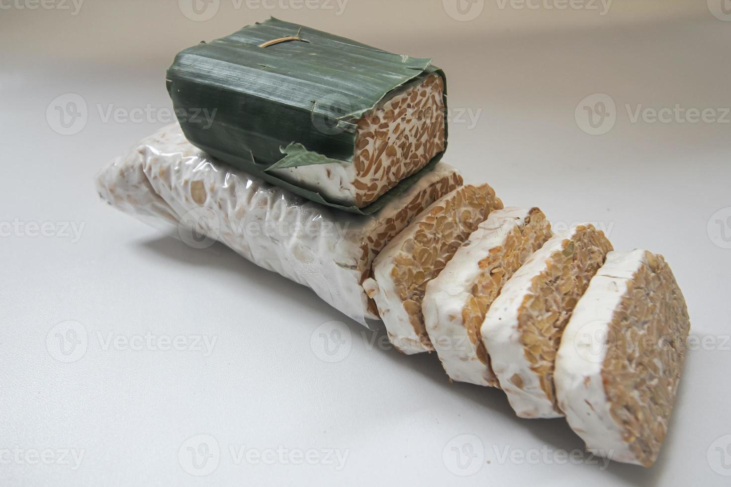 Tempeh Or Tempe is Indonesian traditional food made from fermented soybeans. They are usually wrapped in banana leaves photo