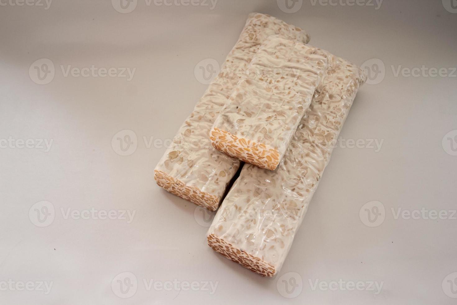 Tempeh Or Tempe is Indonesian traditional food made from fermented soybeans. They are usually wrapped in banana leaves photo