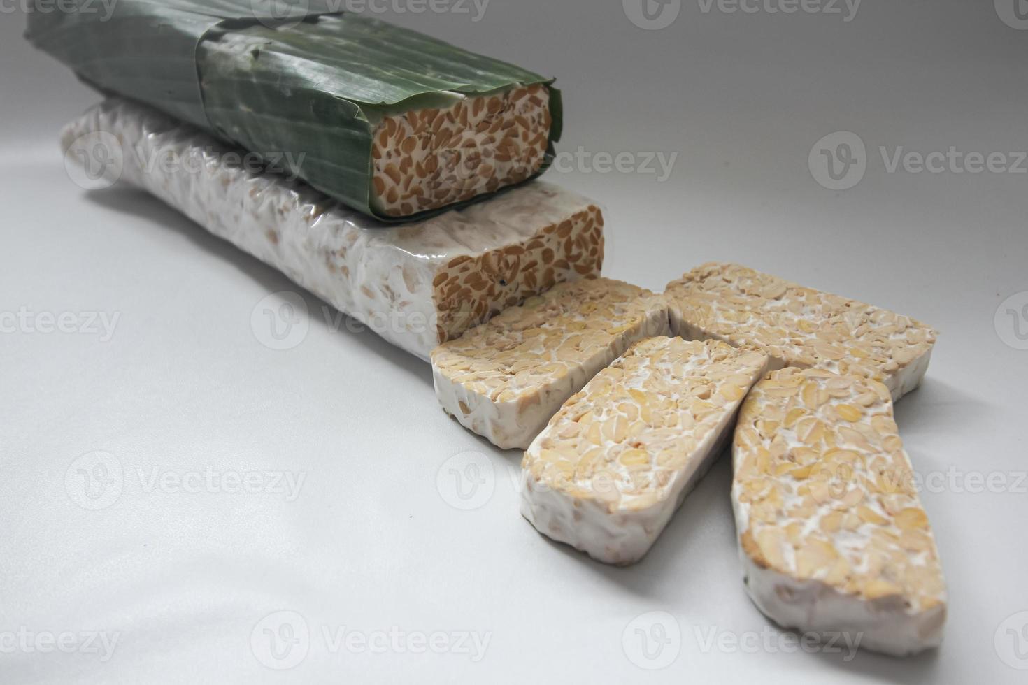 Tempeh Or Tempe is Indonesian traditional food made from fermented soybeans. They are usually wrapped in banana leaves photo