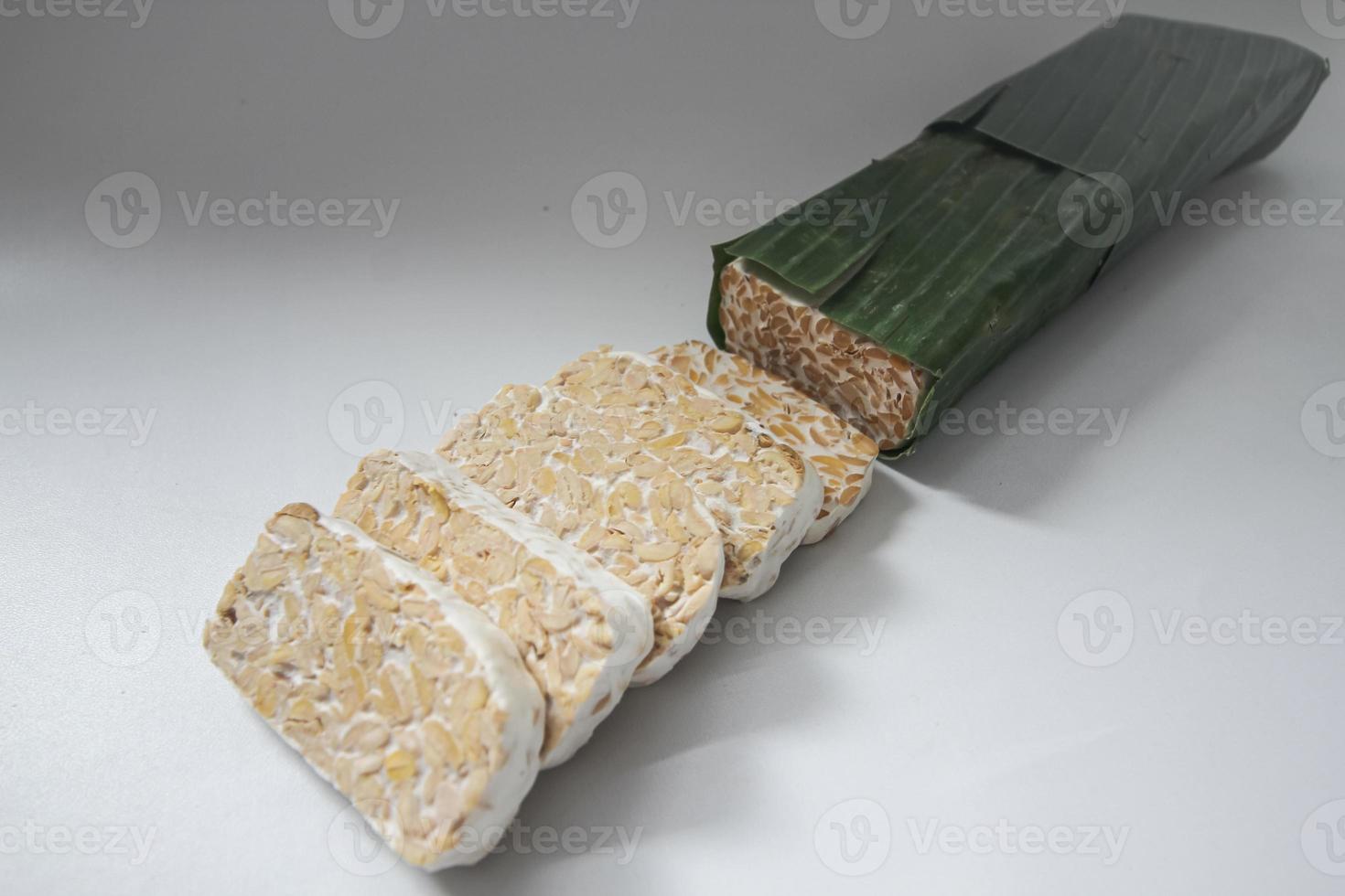 Tempeh Or Tempe is Indonesian traditional food made from fermented soybeans. They are usually wrapped in banana leaves photo