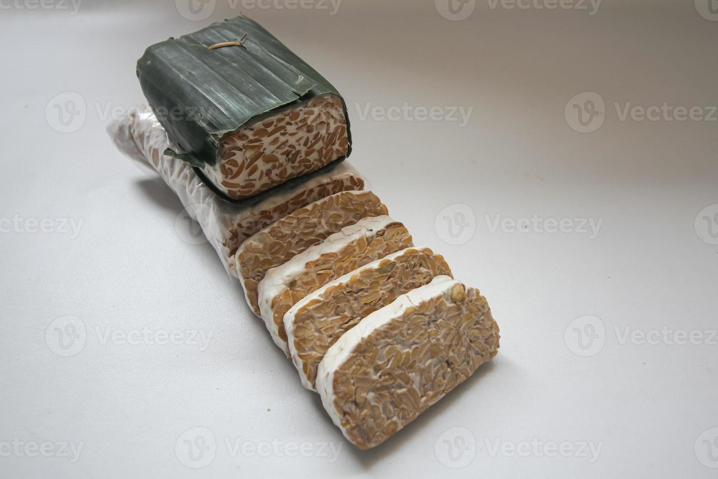Tempeh Or Tempe is Indonesian traditional food made from fermented soybeans. They are usually wrapped in banana leaves photo