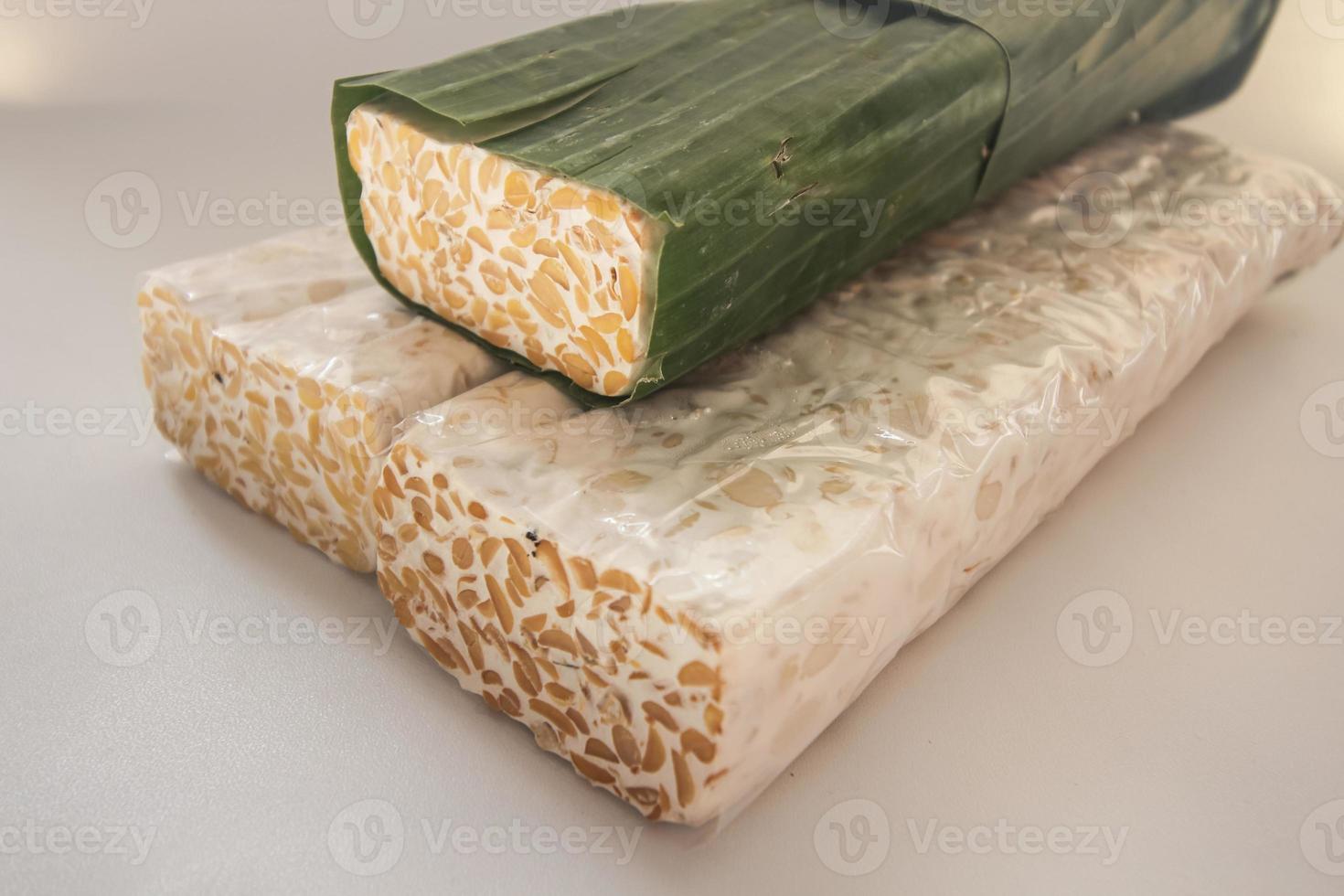 Tempeh Or Tempe is Indonesian traditional food made from fermented soybeans. They are usually wrapped in banana leaves photo