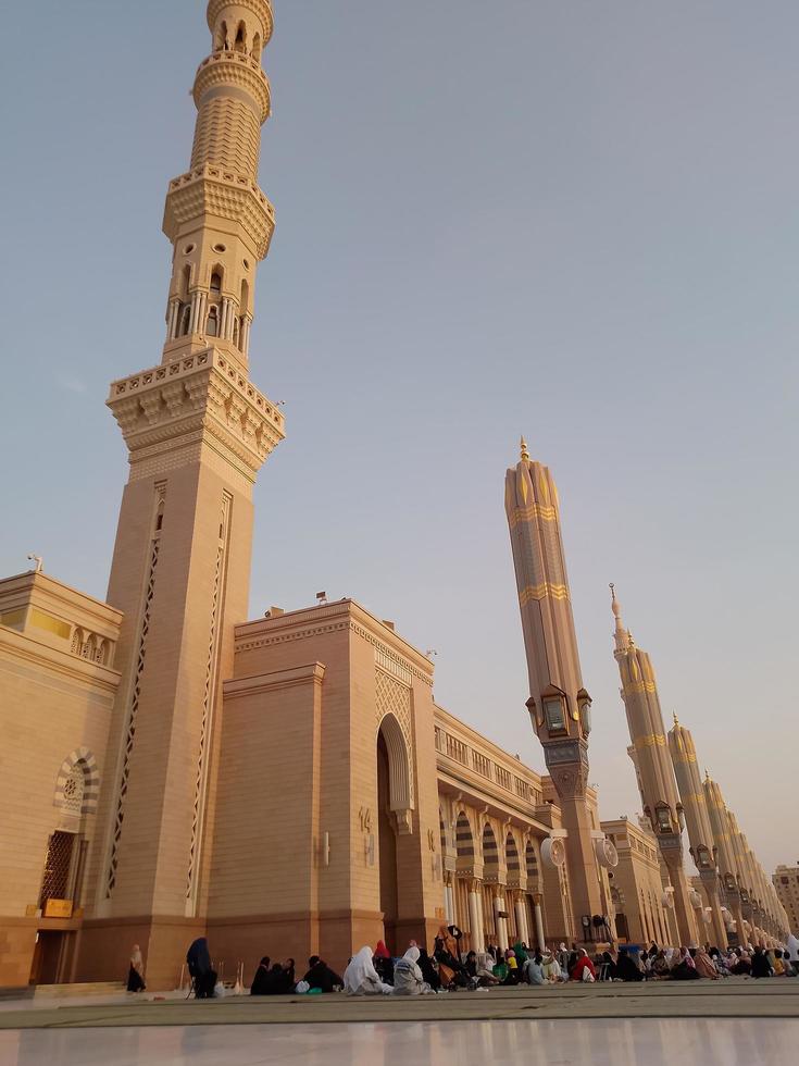 Medina, Saudi Arabia, 2022 - Umbrella construction on the square of Al-Masjid An-Nabawi or Prophet Muhammed Mosque are protecting people from sun at daytime and work as lights at night photo