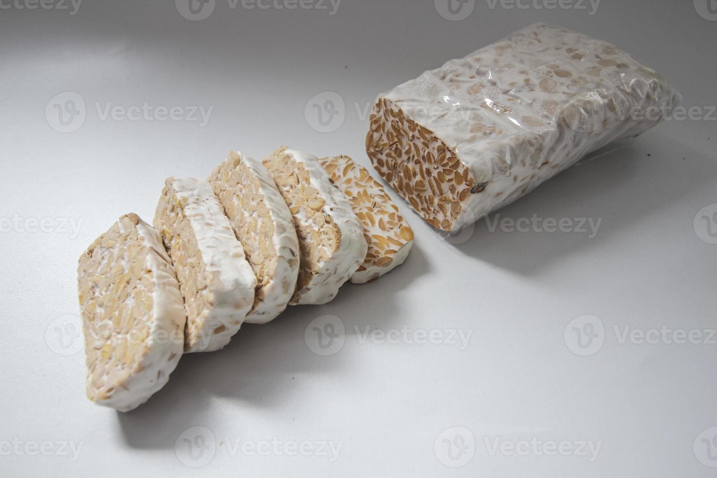 Tempeh Or Tempe is Indonesian traditional food made from fermented soybeans. They are usually wrapped in banana leaves photo