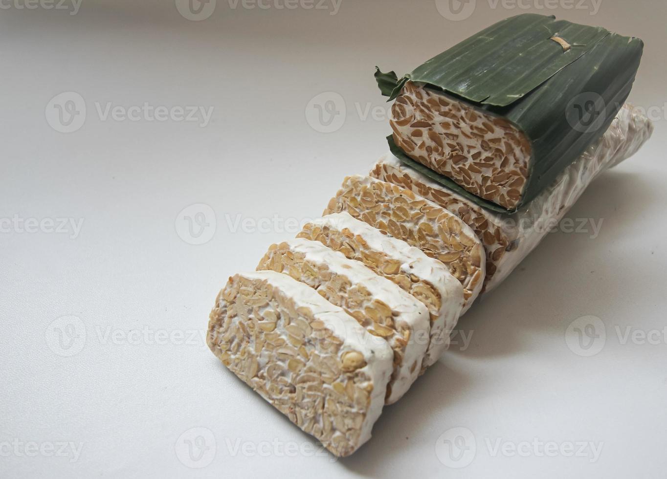 Tempeh Or Tempe is Indonesian traditional food made from fermented soybeans. They are usually wrapped in banana leaves photo